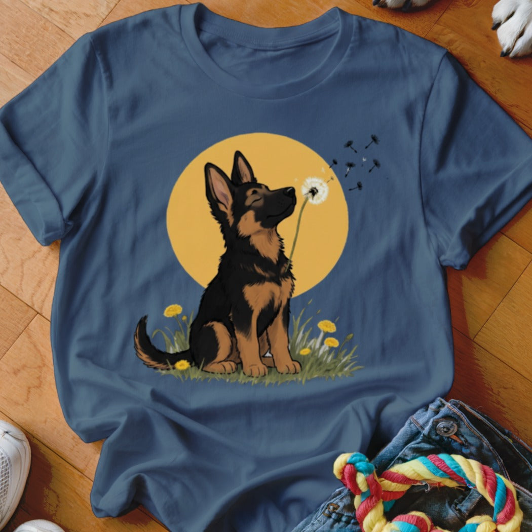 Dark blue crewneck t-shirt featuring a cartoon German Shepherd puppy sniffing a dandelion against a yellow sun.