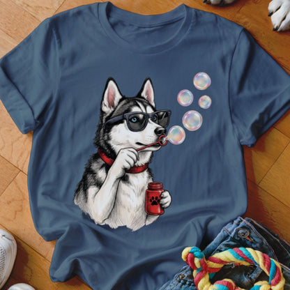 Blue t-shirt featuring an illustration of a husky wearing sunglasses and blowing soap bubbles.