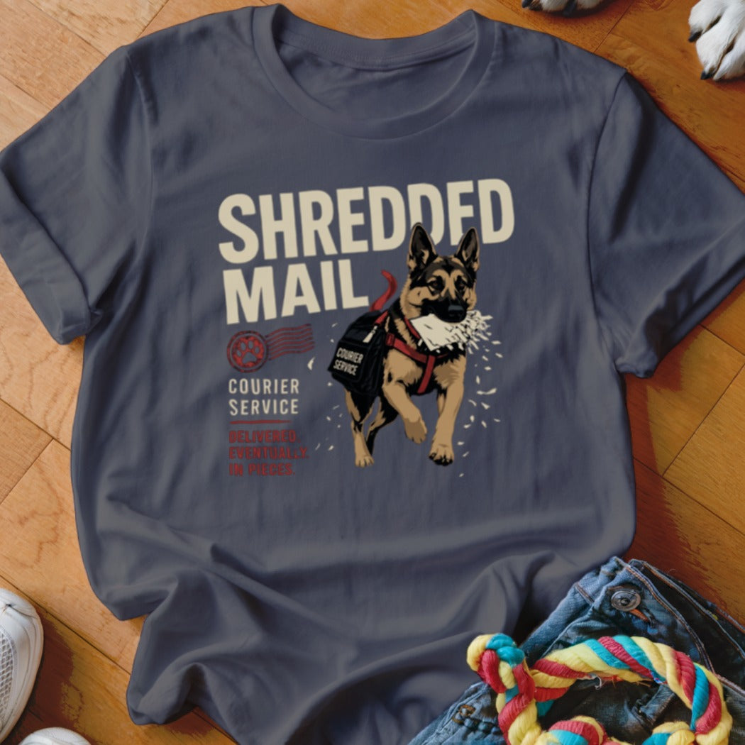 German Shepherd dog wearing a courier bag with "SHREDDED MAIL" printed on shirt.