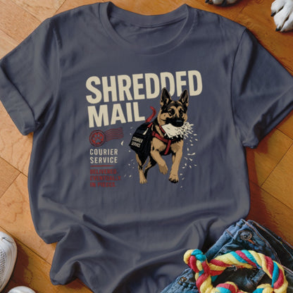 German Shepherd dog wearing a courier bag with "SHREDDED MAIL" printed on shirt.