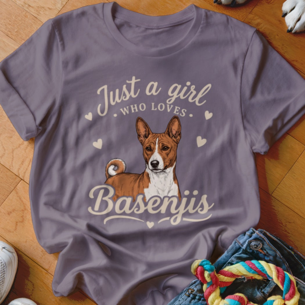 A purple t-shirt featuring a Basenji illustration and the text "Just a girl who loves Basenjis."