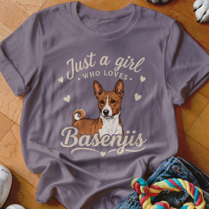 A purple t-shirt featuring a Basenji illustration and the text "Just a girl who loves Basenjis."