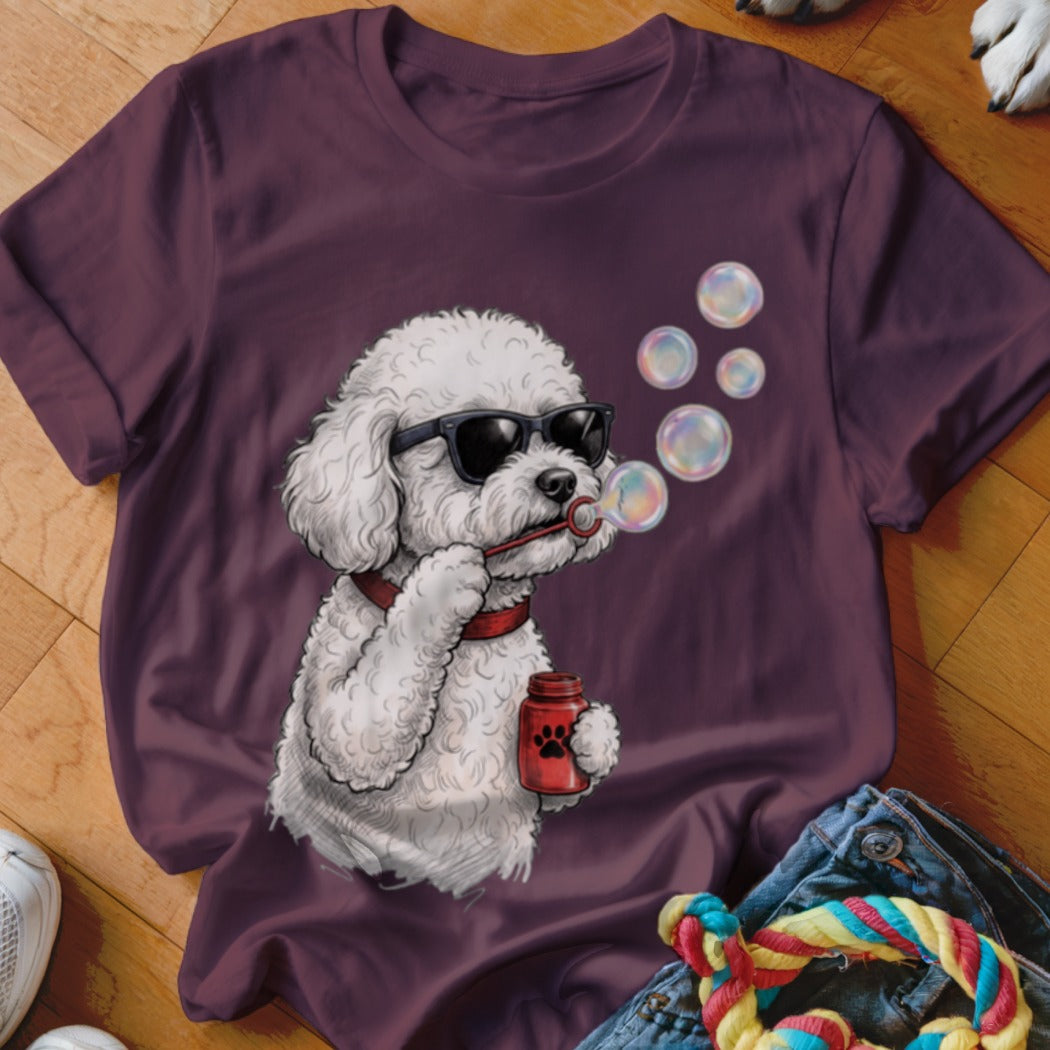 Maroon t-shirt featuring a graphic of a white poodle wearing sunglasses and blowing bubbles.