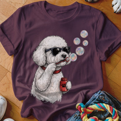 Maroon t-shirt featuring a graphic of a white poodle wearing sunglasses and blowing bubbles.