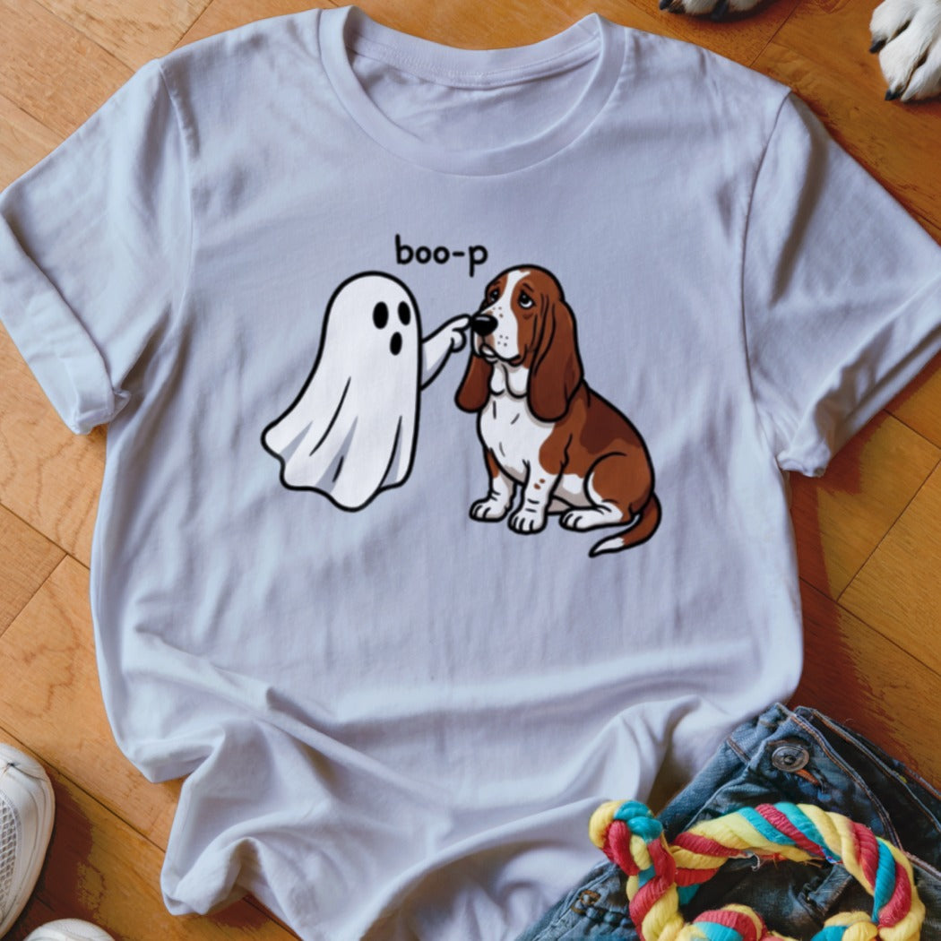 A cartoon ghost playfully boops a Basset Hound on the nose.