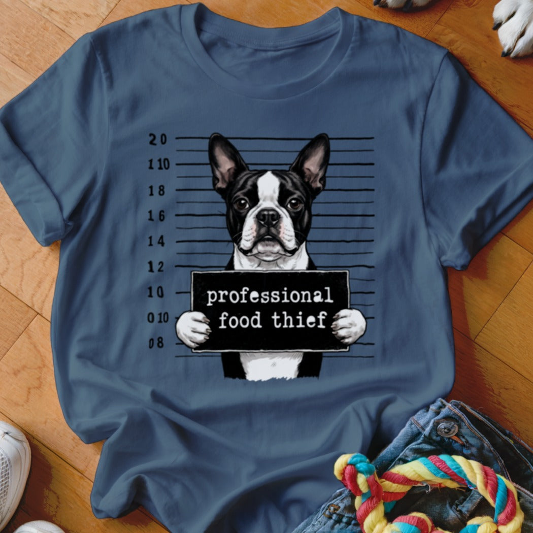 Boston Terrier mugshot with "professional food thief" sign and height markers.