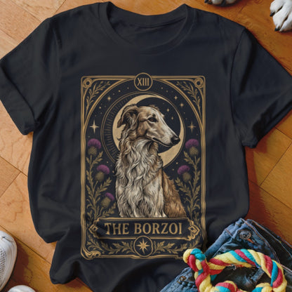 A black t-shirt printed with a tarot card design featuring a borzoi dog, moon, and thistles.