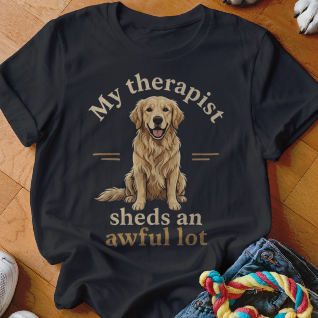 Black t-shirt with golden retriever graphic and text "My therapist sheds an awful lot."