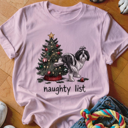 A light pink t-shirt features a graphic of a black and white dog urinating on a Christmas tree, with the text "naughty list" underneath.