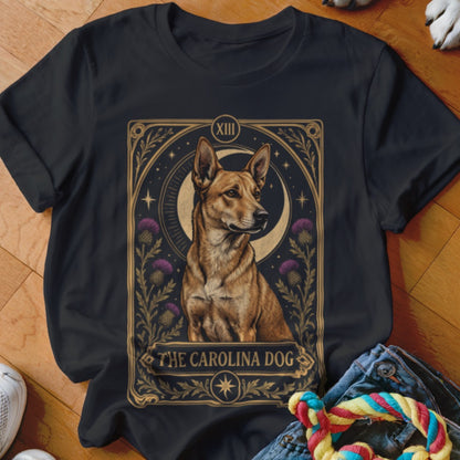 A black t-shirt features a tarot card graphic depicting a Carolina dog framed by thistles and a crescent moon.