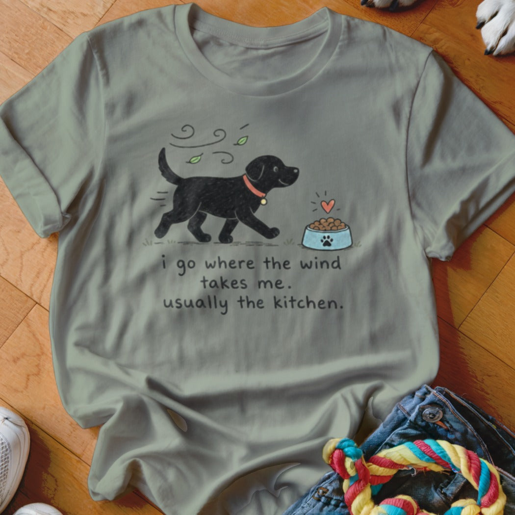 Gray t-shirt with a black dog graphic and text "i go where the wind takes me. usually the kitchen."