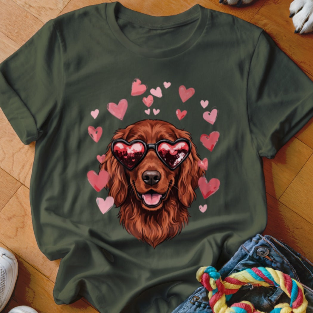 Dark green t-shirt featuring a graphic of a brown dog wearing heart-shaped sunglasses surrounded by pink hearts.