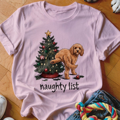 Pink t-shirt with a dog by a Christmas tree, text "naughty list".