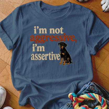 Blue t-shirt with text "i'm not aggressive, i'm assertive" and a dog illustration.
