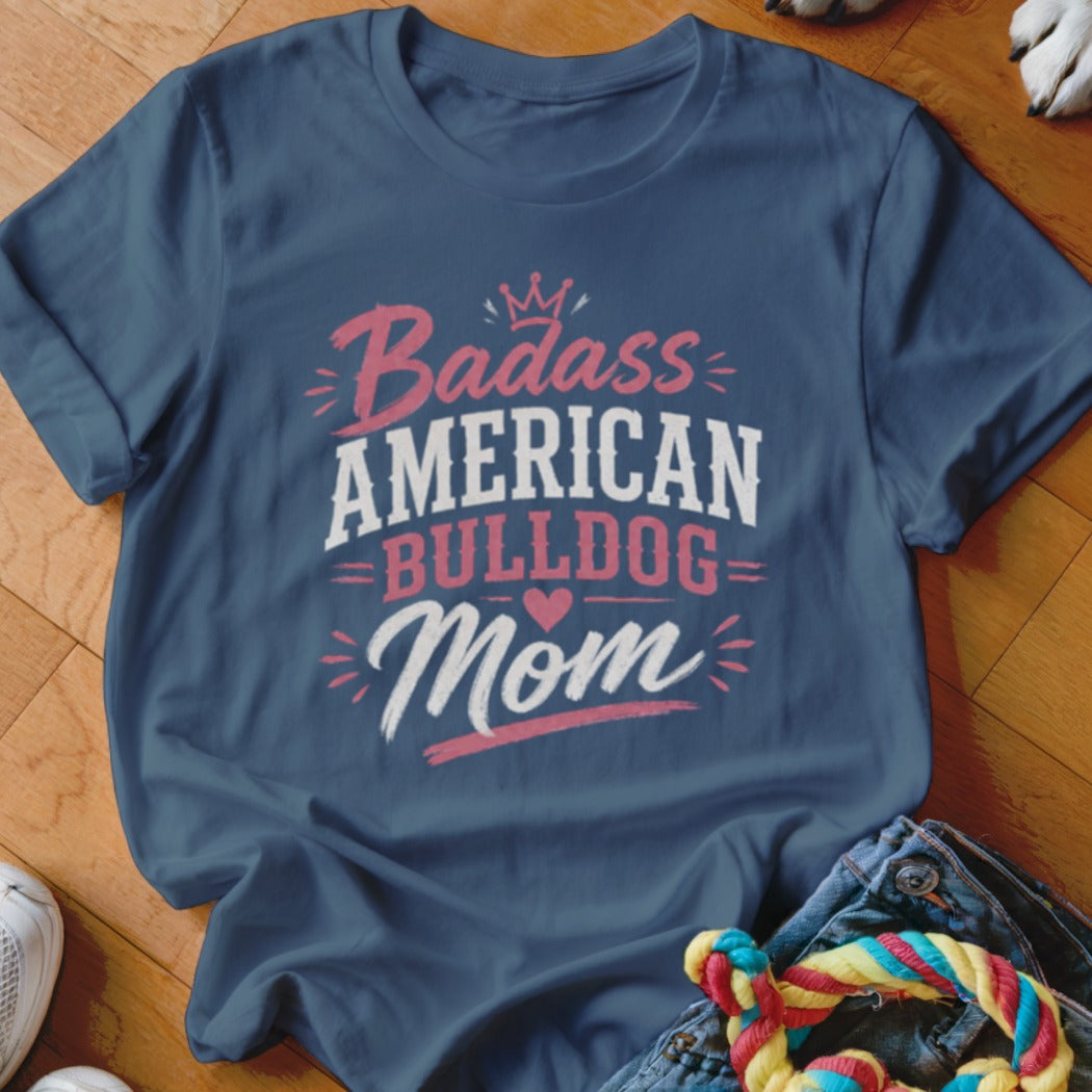 Navy t-shirt with "Badass American Bulldog Mom" text and a crown graphic.