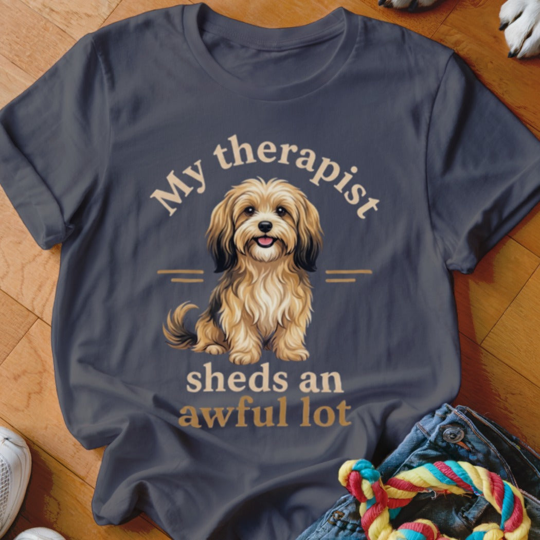 Dark gray t-shirt with illustration of a shaggy dog and text "My therapist sheds an awful lot".