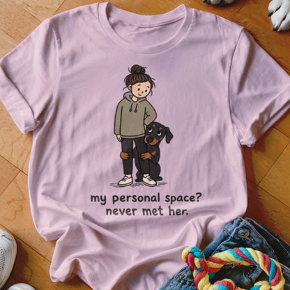 Light pink t-shirt with illustration of girl and dog, text reads "my personal space? never met her."