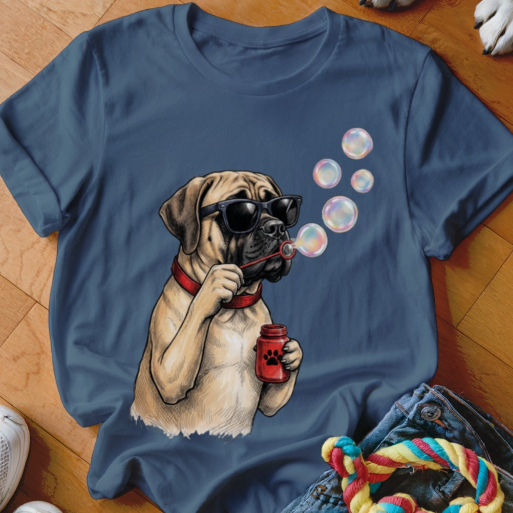 A blue t-shirt printed with a cartoon dog wearing sunglasses and blowing soap bubbles.