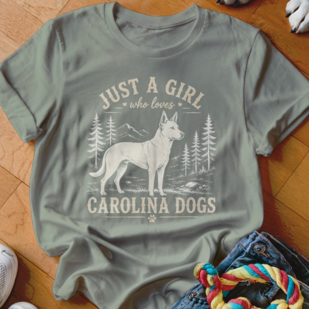 Light green t-shirt with white graphic of Carolina Dog, trees, and text "Just a girl who loves Carolina dogs."