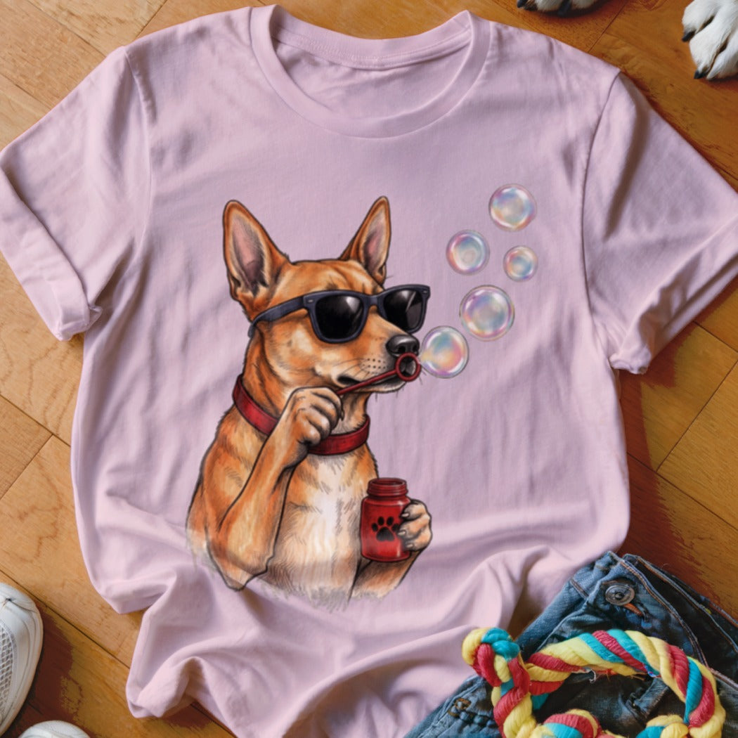 Light pink t-shirt featuring an illustrated dog wearing sunglasses and blowing soap bubbles.
