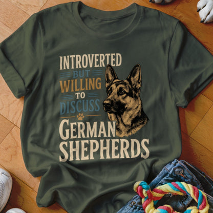 Green t-shirt with "Introverted but willing to discuss German Shepherds" text and dog illustration.