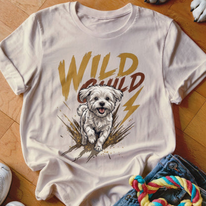 A light pink t-shirt with a graphic of a white puppy and the words Wild Child.