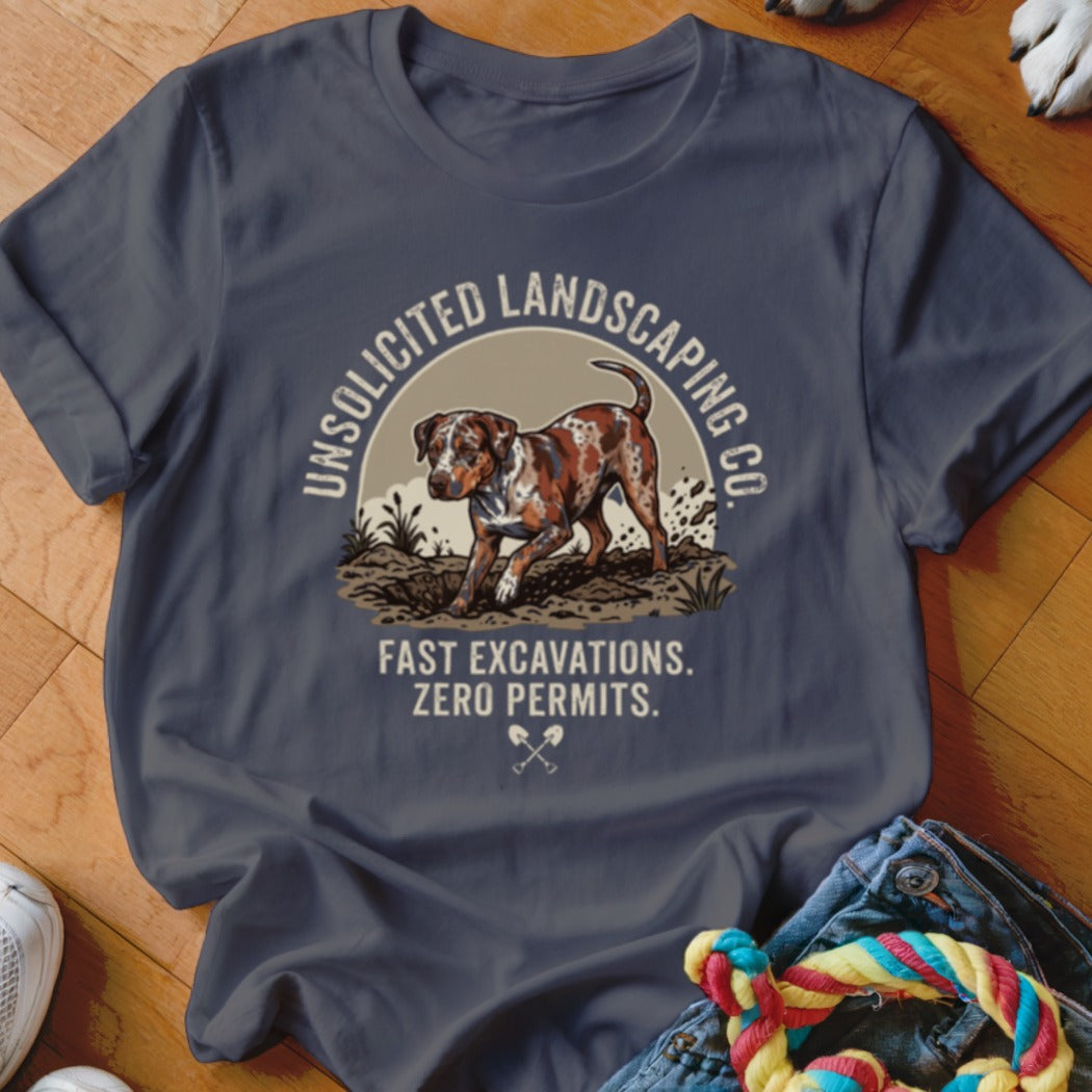 T-shirt with a dog digging and text "UNSOLICITED LANDSCAPING CO. FAST EXCAVATIONS. ZERO PERMITS."