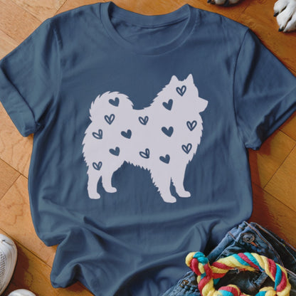 Blue t-shirt with a white silhouette of a dog covered in small hearts.