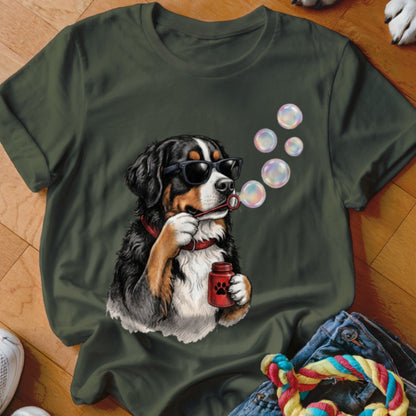 Dark green t-shirt featuring a graphic of a Bernese Mountain Dog wearing sunglasses and blowing bubbles.