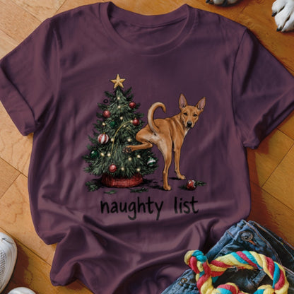 Brown dog with one leg raised near Christmas tree, text "naughty list" below.
