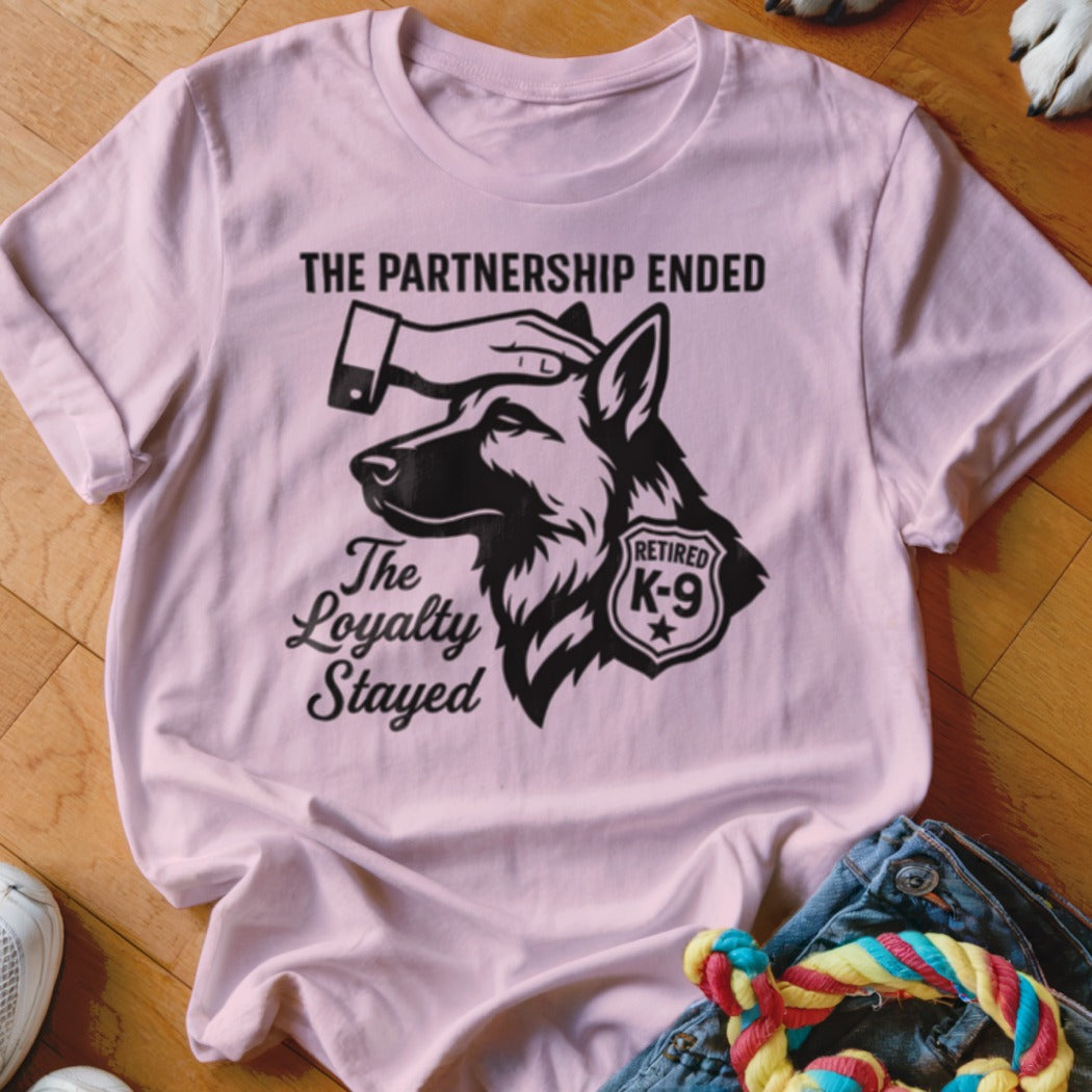 Pink t-shirt with retired K-9 graphic saying "The Partnership Ended, The Loyalty Stayed".