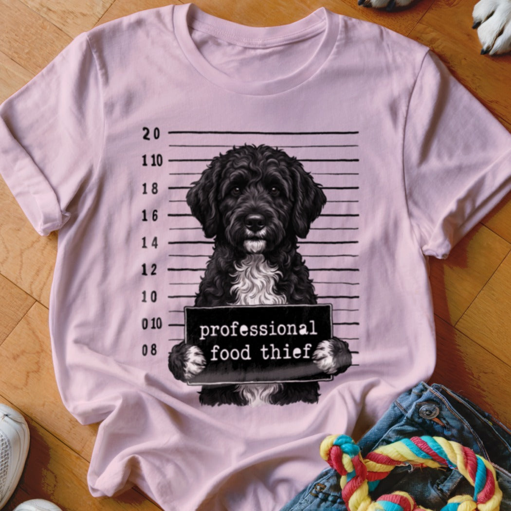 Pink t-shirt with a black poodle mugshot graphic reading "professional food thief".