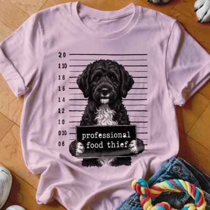 Pink t-shirt with a black poodle mugshot graphic reading "professional food thief".