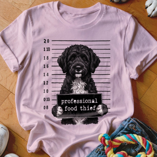 Pink t-shirt with a black poodle mugshot graphic reading "professional food thief".