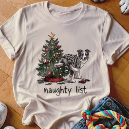 T-shirt with a dog lifting its leg next to a Christmas tree and the text "naughty list".