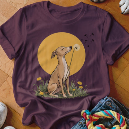 Maroon t-shirt featuring an illustration of a dog blowing dandelion seeds against a yellow circle background.
