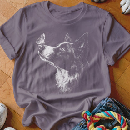 Mauve crewneck t-shirt featuring a white line drawing of a border collie looking at a butterfly on its nose.