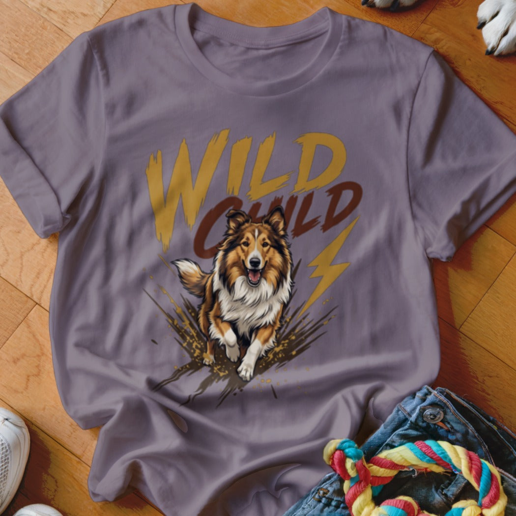 A dusty purple t-shirt featuring a graphic of a running Sheltie dog and the text WILD CHILD.