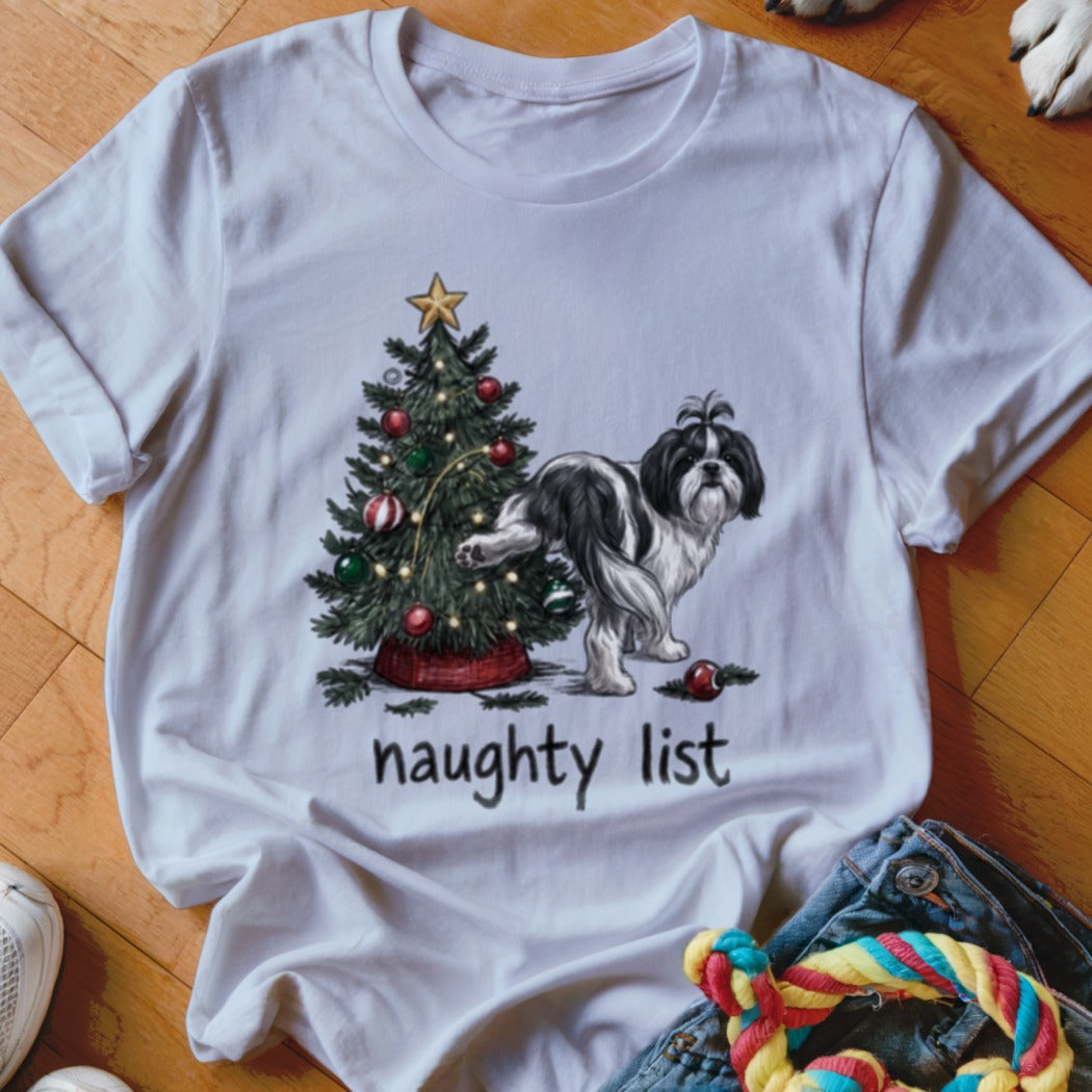 A white t-shirt featuring a graphic of a Shih Tzu dog next to a Christmas tree and the text naughty list.
