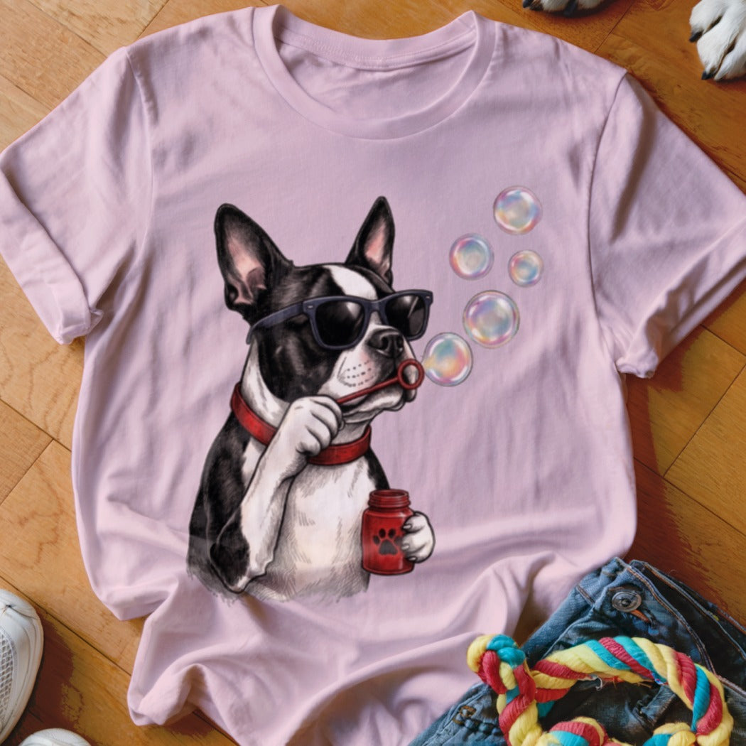 Light pink t-shirt featuring a graphic of a Boston Terrier wearing sunglasses and blowing bubbles.