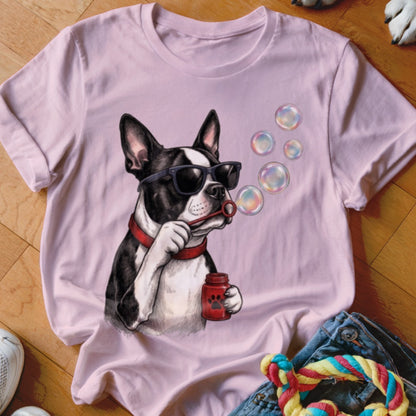 Light pink t-shirt featuring a graphic of a Boston Terrier wearing sunglasses and blowing bubbles.