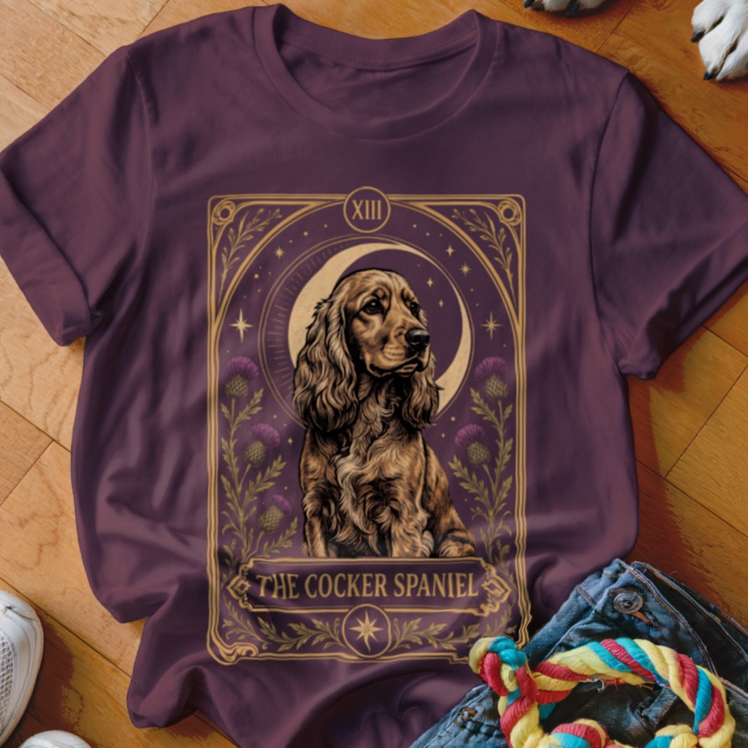 Maroon t-shirt featuring a tarot card graphic of a cocker spaniel with a crescent moon.