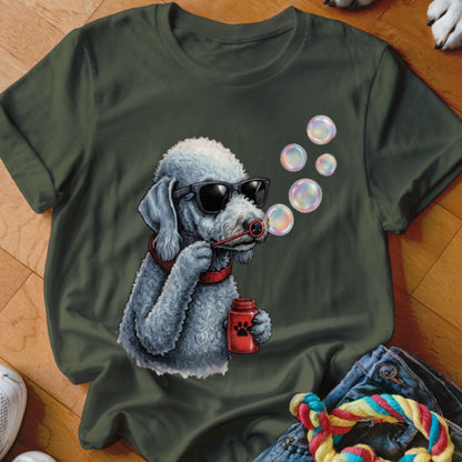 A dark green t-shirt features a graphic of a gray poodle wearing sunglasses and blowing bubbles.