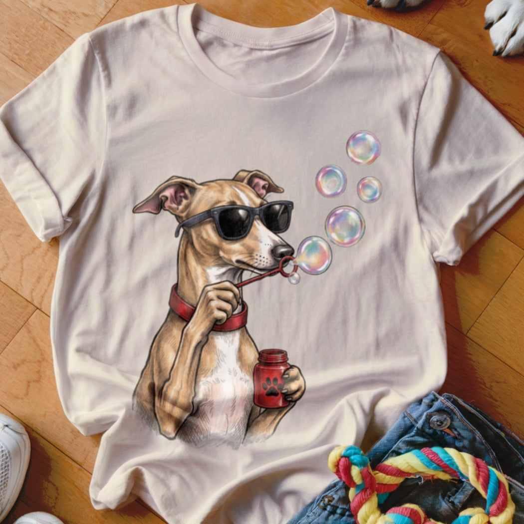 Beige t-shirt featuring a graphic of a dog wearing sunglasses and blowing soap bubbles.