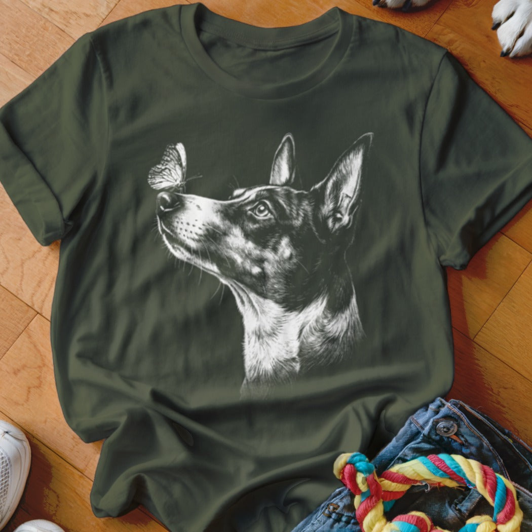Dark green t-shirt featuring a white sketch graphic of a dog looking at a butterfly on its nose.