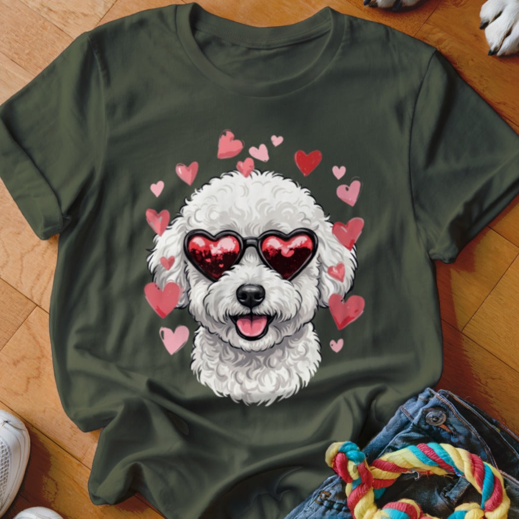 Dark green t-shirt featuring a graphic of a white fluffy dog wearing heart-shaped sunglasses surrounded by pink hearts.