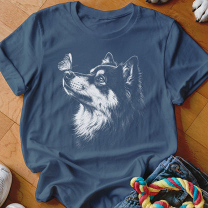 A dark blue t-shirt printed with a white sketch of a husky looking at a butterfly.