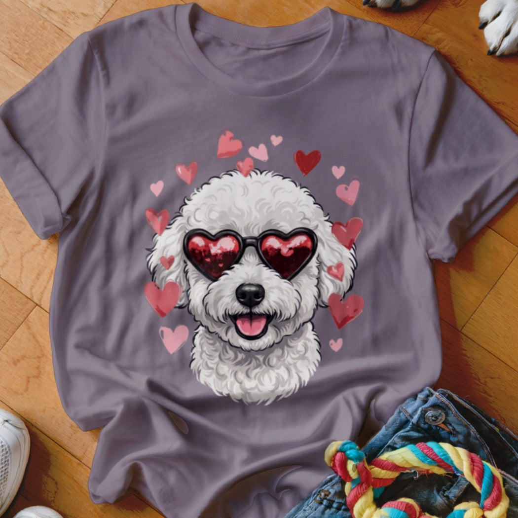 A gray t-shirt featuring a graphic of a white poodle wearing heart-shaped sunglasses, surrounded by pink and red hearts.