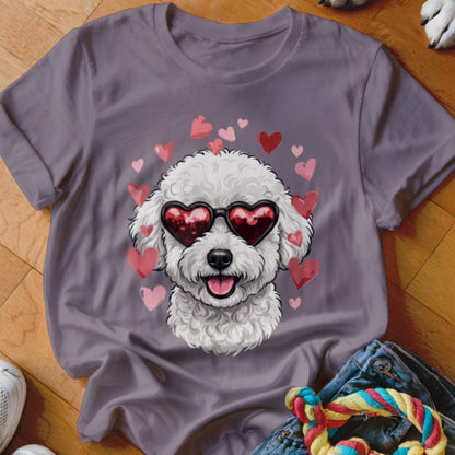 A gray t-shirt featuring a graphic of a white poodle wearing heart-shaped sunglasses, surrounded by pink and red hearts.