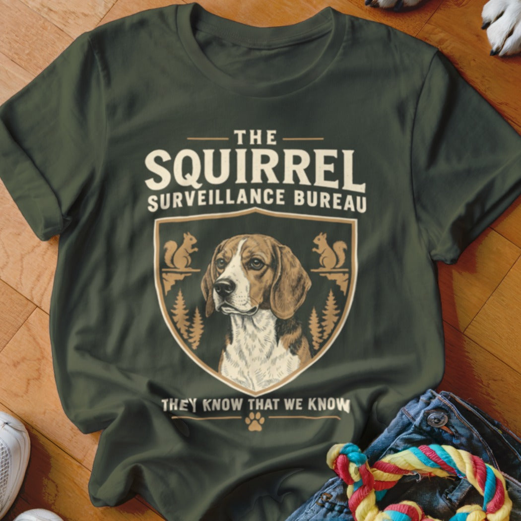 Dark green t-shirt featuring a graphic with a beagle, squirrels, and the text The Squirrel Surveillance Bureau.